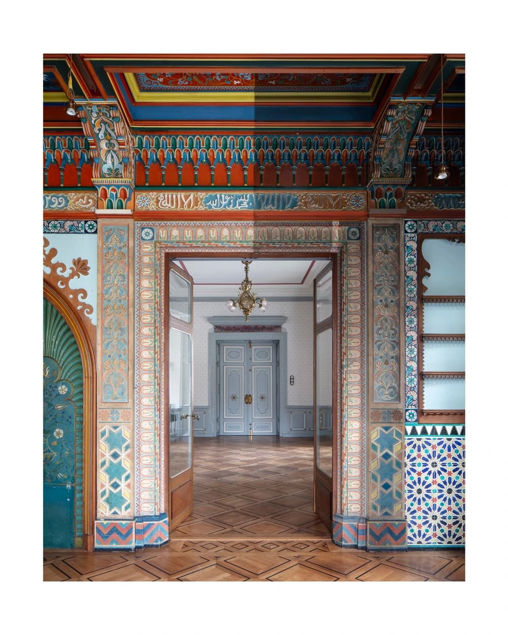 An ornate doorway in the Salon mauresque in Neuchâtel, with painted wood, stucco and decorative ceramic surfaces.